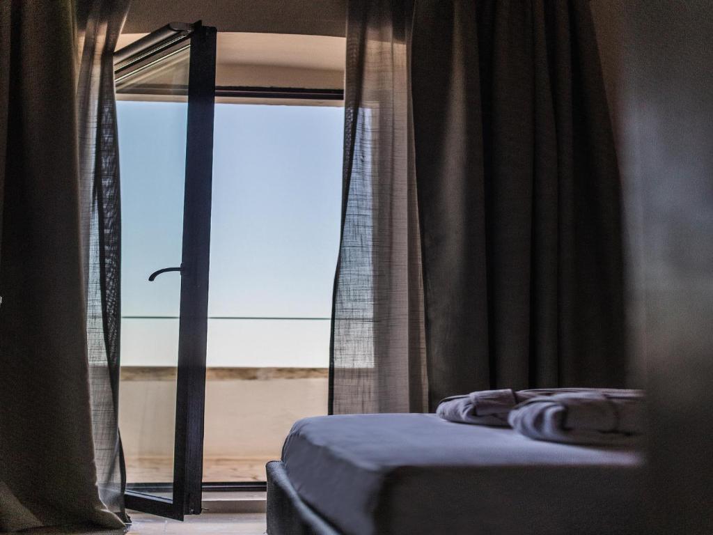 Кровать или кровати в номере La Sommità Relais & Chateaux