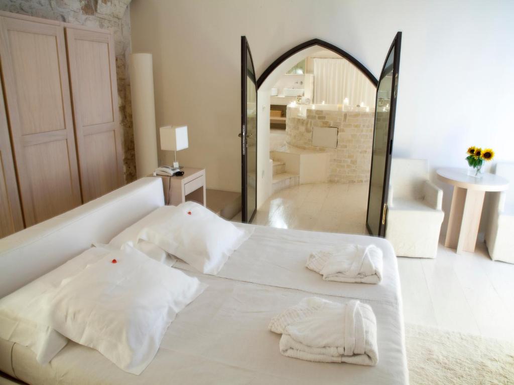 Кровать или кровати в номере La Sommità Relais & Chateaux