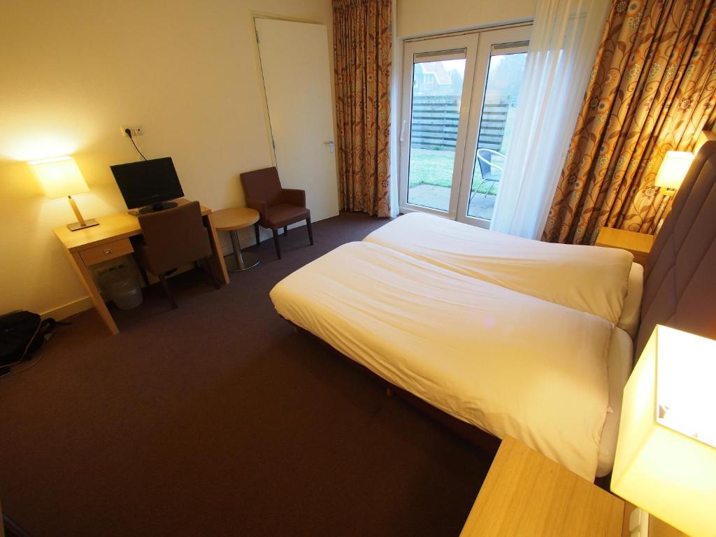 Postel nebo postele na pokoji v ubytování Hotel Bos en Duinzicht