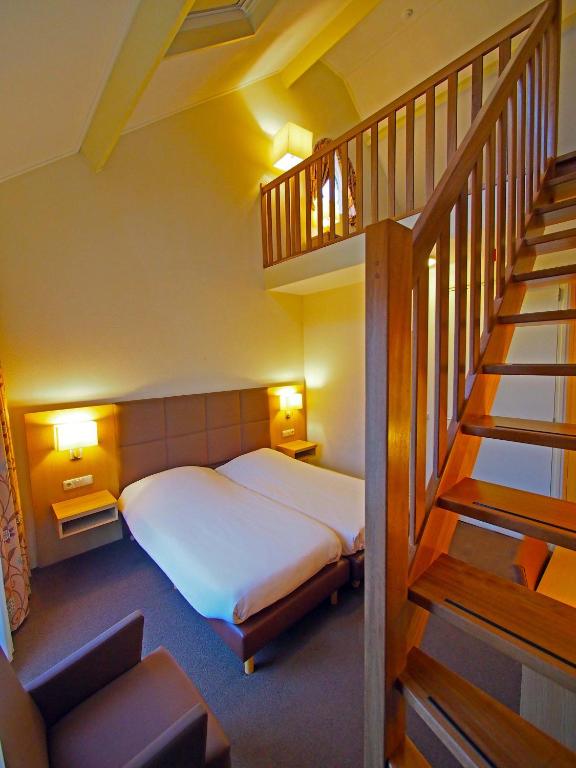 Postel nebo postele na pokoji v ubytování Hotel Bos en Duinzicht