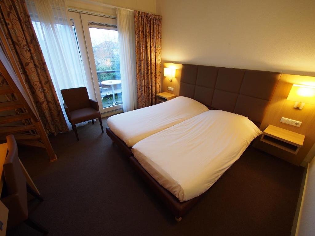 Postel nebo postele na pokoji v ubytování Hotel Bos en Duinzicht