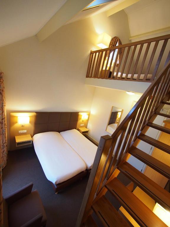 Postel nebo postele na pokoji v ubytování Hotel Bos en Duinzicht