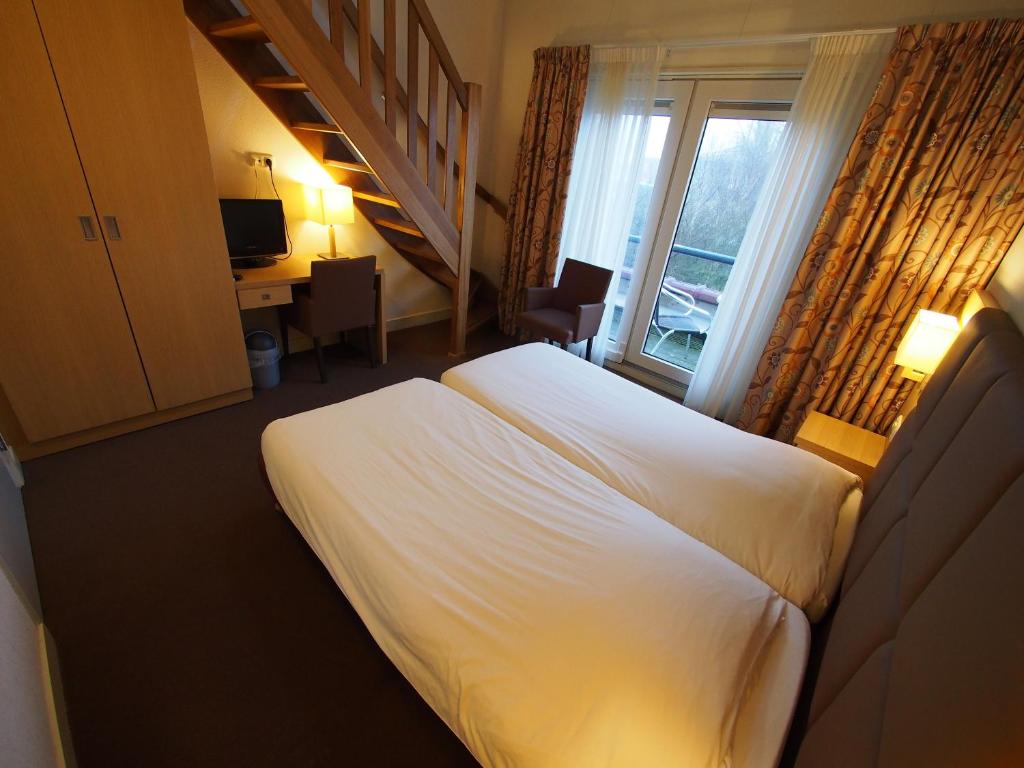 Postel nebo postele na pokoji v ubytování Hotel Bos en Duinzicht