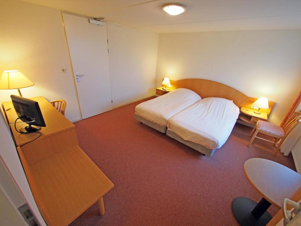 Postel nebo postele na pokoji v ubytování Hotel Bos en Duinzicht