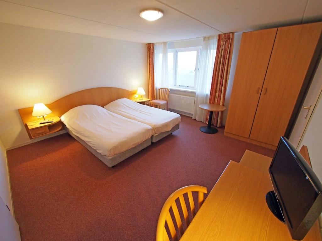 Postel nebo postele na pokoji v ubytování Hotel Bos en Duinzicht