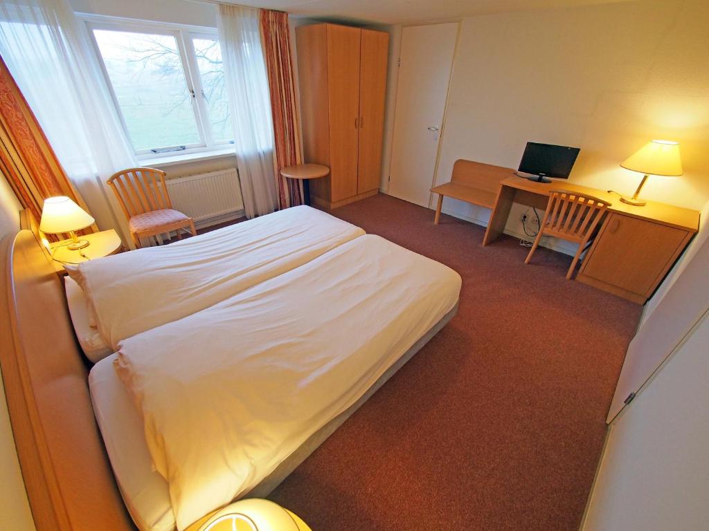 Postel nebo postele na pokoji v ubytování Hotel Bos en Duinzicht