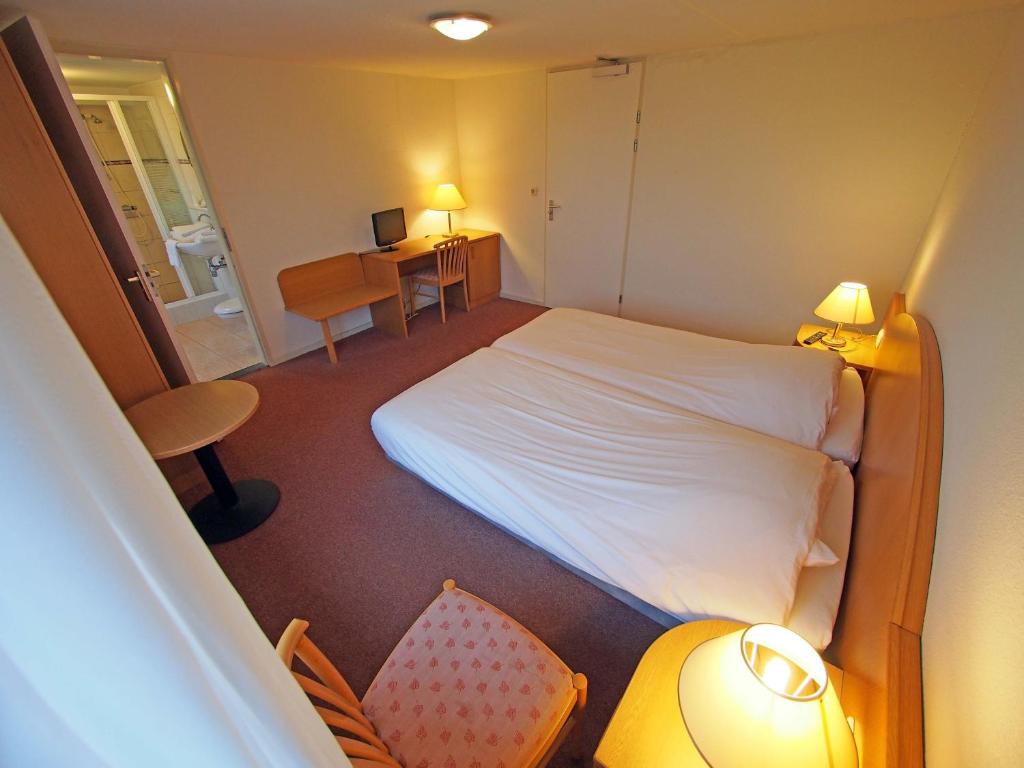 Postel nebo postele na pokoji v ubytování Hotel Bos en Duinzicht