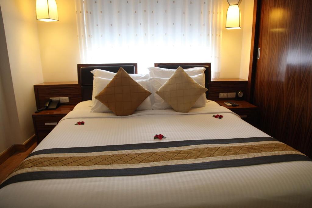 Postel nebo postele na pokoji v ubytování Elite Central Hotel Hanoi