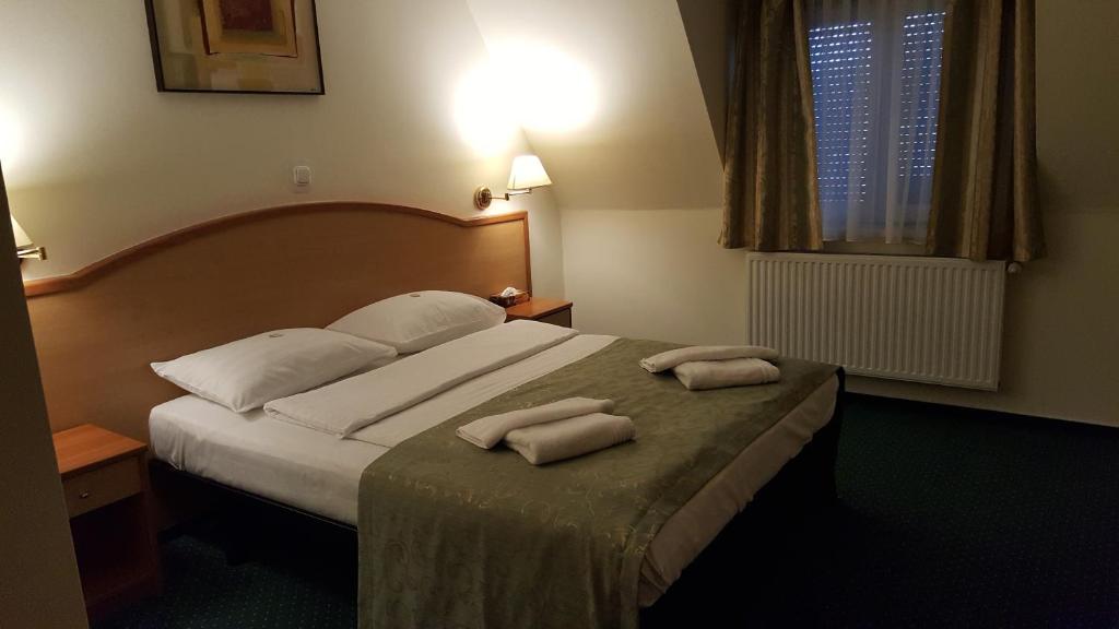Postel nebo postele na pokoji v ubytování Hotel Melody