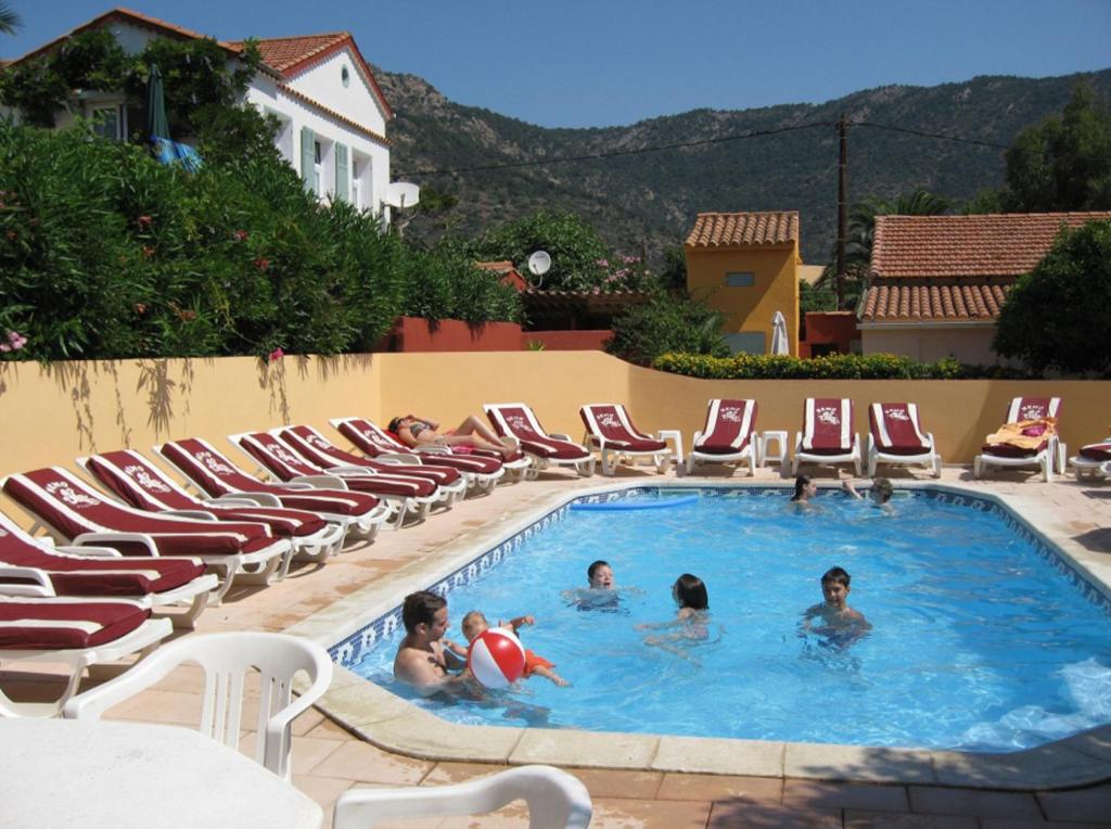 a group of people in a swimming pool with chairs at Plage de Saint Clair à 50m in Le Lavandou