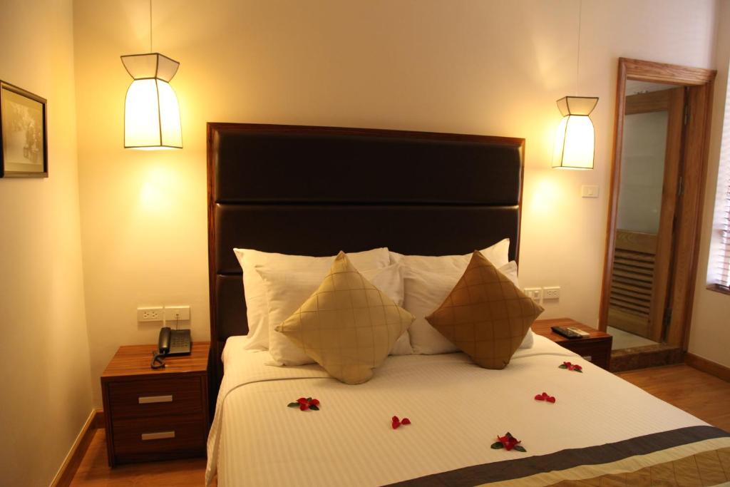 Postel nebo postele na pokoji v ubytování Elite Central Hotel Hanoi