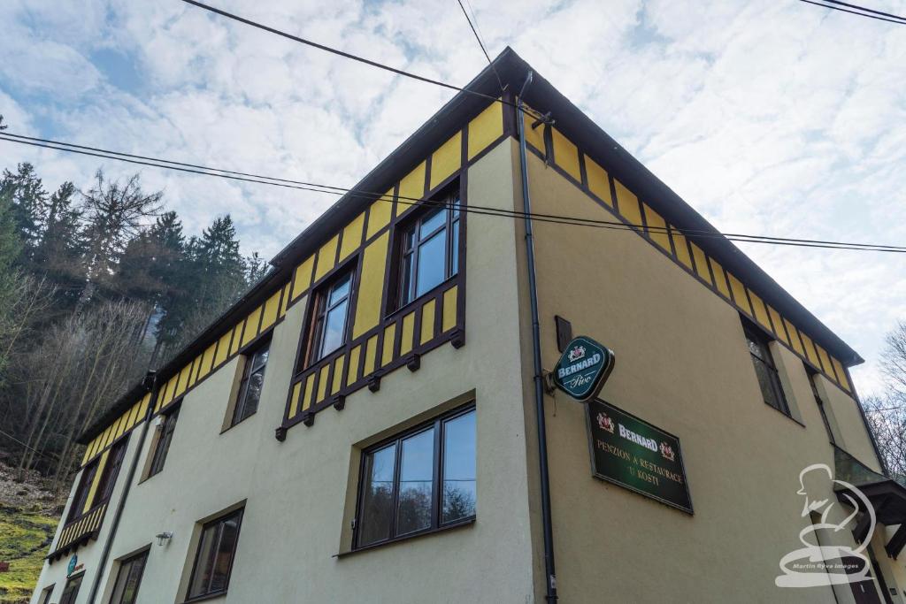 a building with yellow stripes on the side of it at U Kosti - Bohemian Switzerland in Děčín