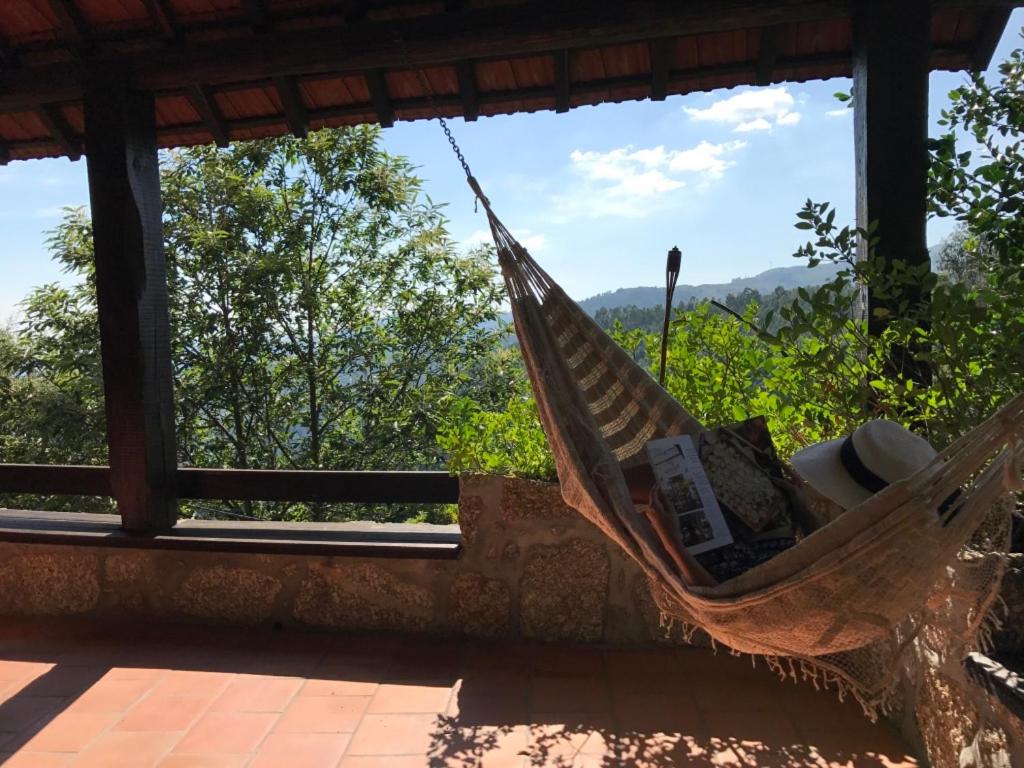 a hammock in a room with a view at Casa da Cresso in Amares