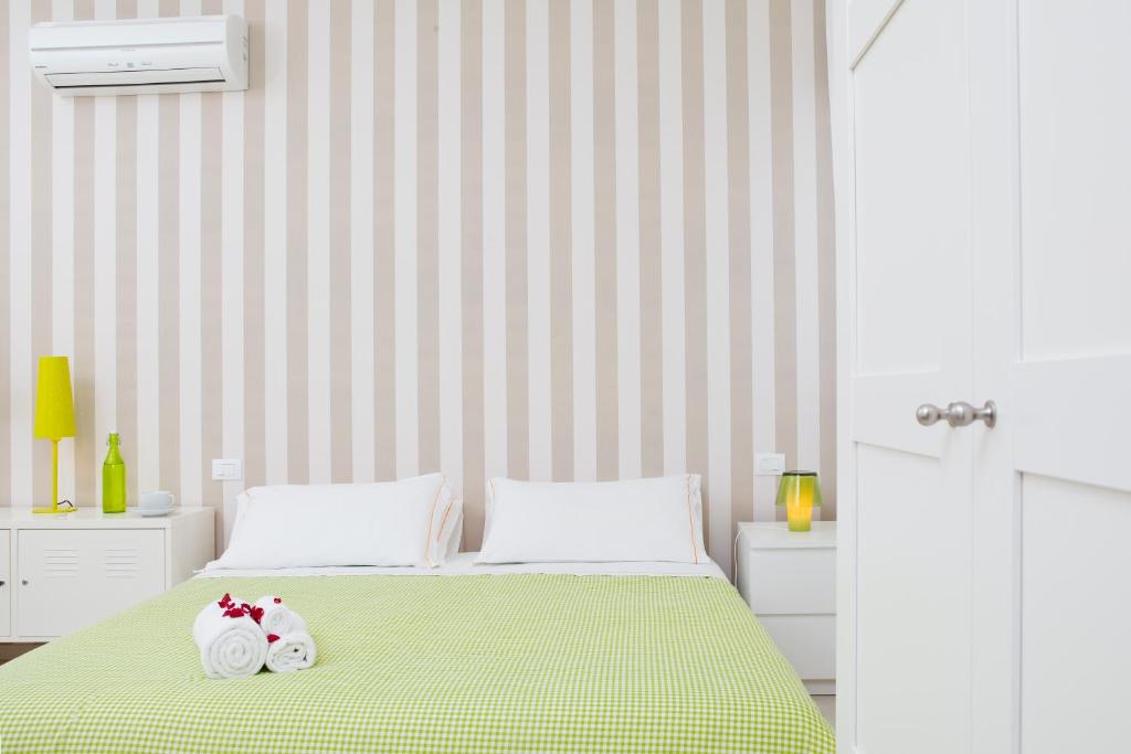 a bedroom with a bed with two towels on it at Il Vicolo B&B in Milazzo