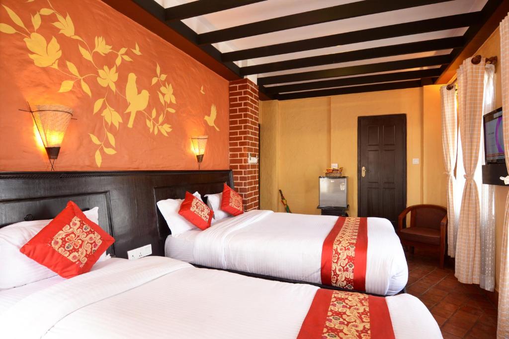 Postel nebo postele na pokoji v ubytování Kasthamandap Boutique Hotel