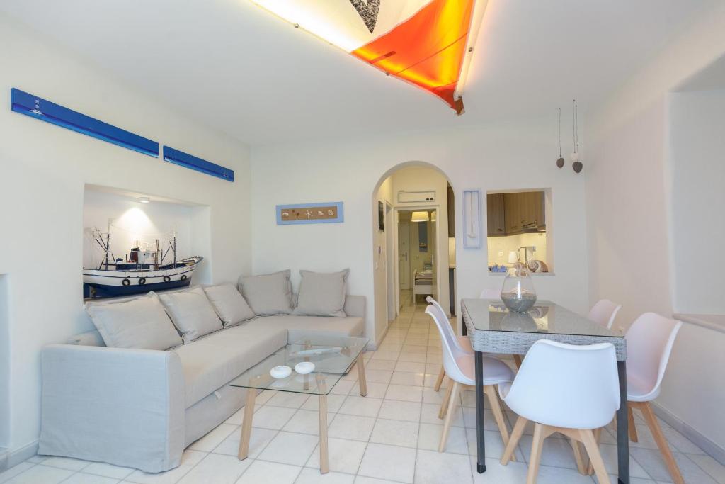 a living room with a couch and a table at PEBBLES 1BD house with Sea View in the heart of Naousa in Naousa