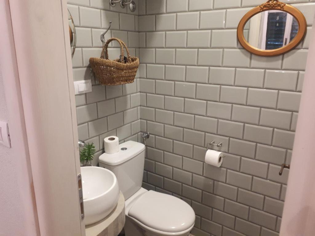 a small bathroom with a toilet and a mirror at House Grabic in Tivat