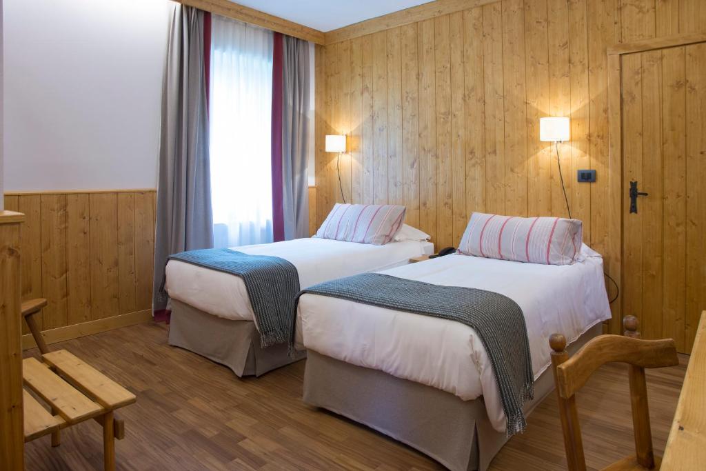 Postel nebo postele na pokoji v ubytování Albergo Ristorante Bucaneve