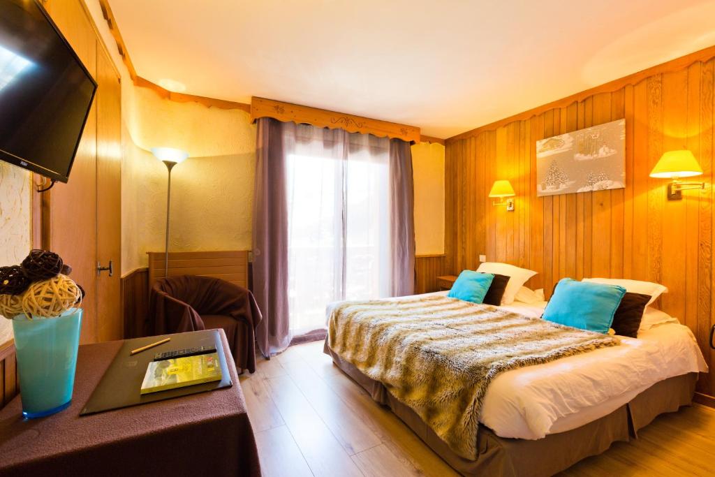 Postel nebo postele na pokoji v ubytování Hôtel Les Airelles