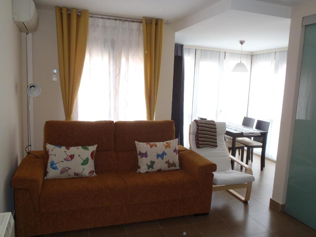 a living room with a couch and a dining table at El Balconcito de San Millán III in Segovia