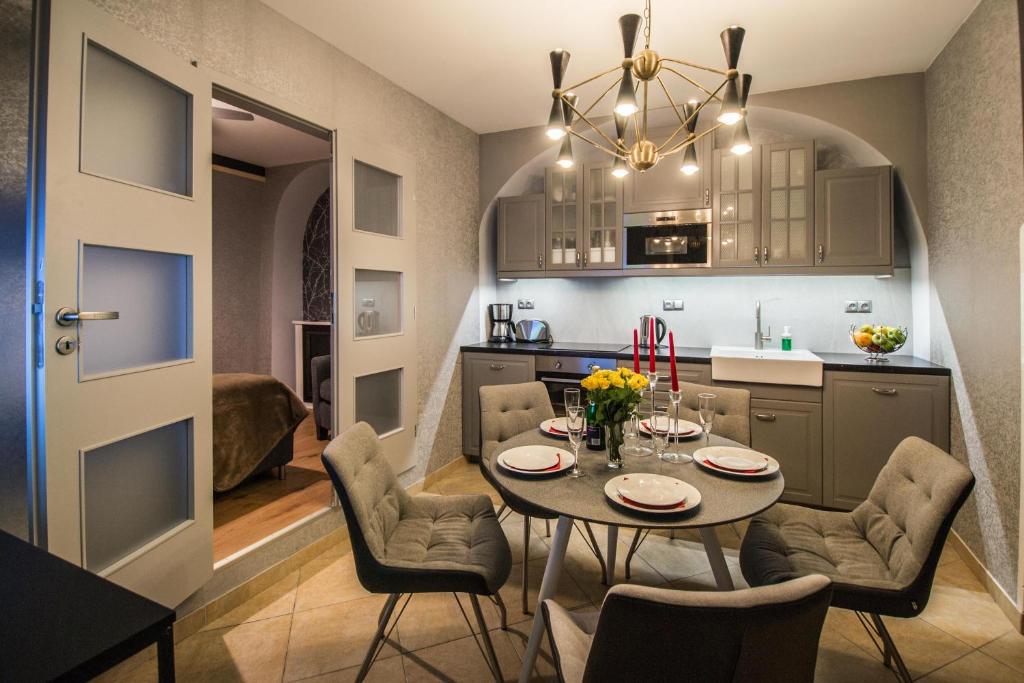 a kitchen and dining room with a table and chairs at Unique Apt 250m from the Charles Bridge in Prague