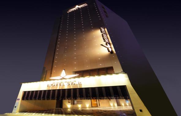 a hotel building at night with a star on it at Hotel Star in Seoul