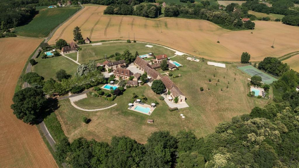 an aerial view of a large house on a field at Le Domaine des Fargues in Sainte-Foy-de-Longas