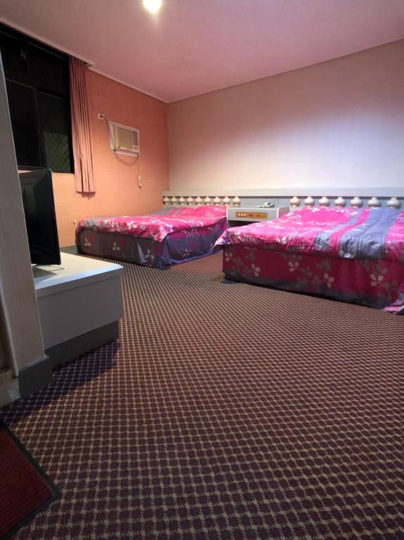 Postel nebo postele na pokoji v ubytování Ya Shi Deng Hotel