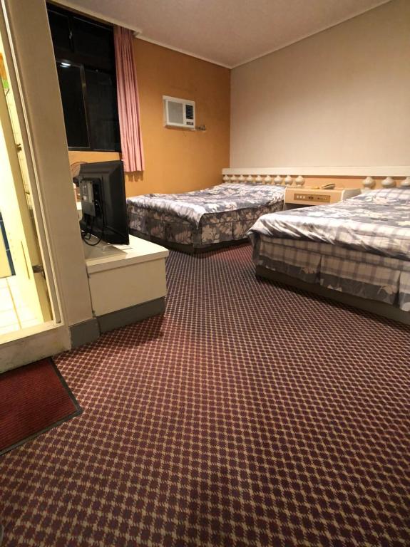 Postel nebo postele na pokoji v ubytování Ya Shi Deng Hotel