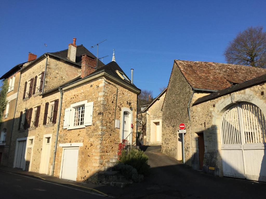 an old stone building with a stop sign on a street at The Salt House in Avoise
