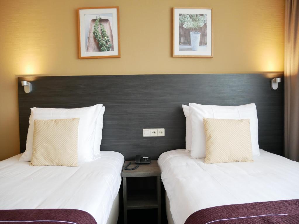 Postel nebo postele na pokoji v ubytování Hotel het Oosten