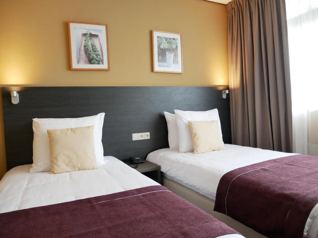 Postel nebo postele na pokoji v ubytování Hotel het Oosten