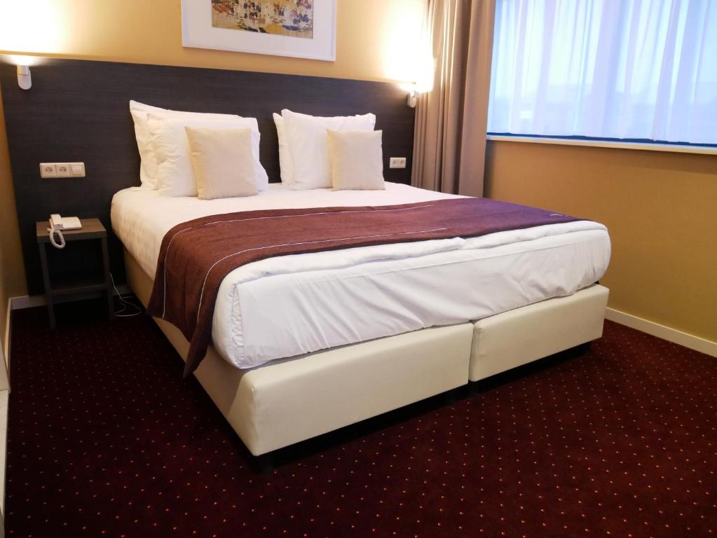 Postel nebo postele na pokoji v ubytování Hotel het Oosten