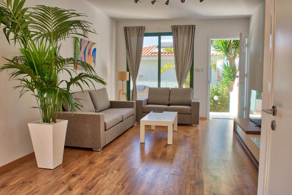 a living room with a couch and a table at Julipapas Gardens in Paphos