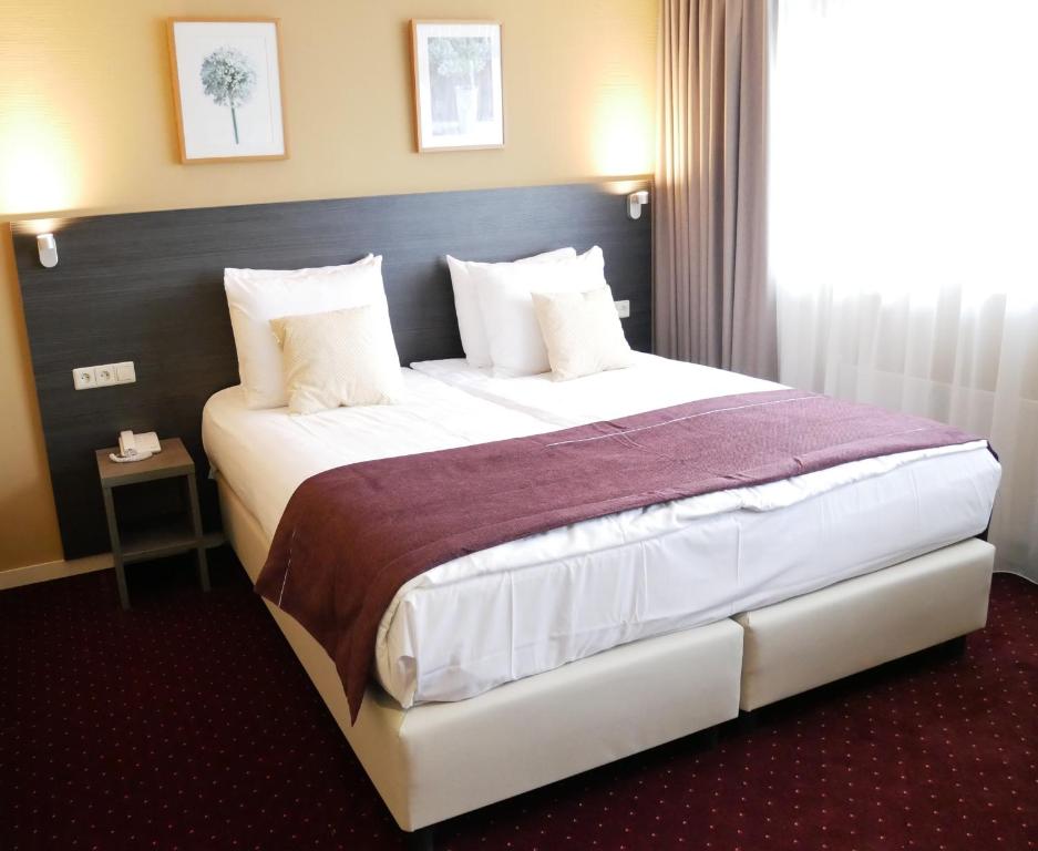 Postel nebo postele na pokoji v ubytování Hotel het Oosten