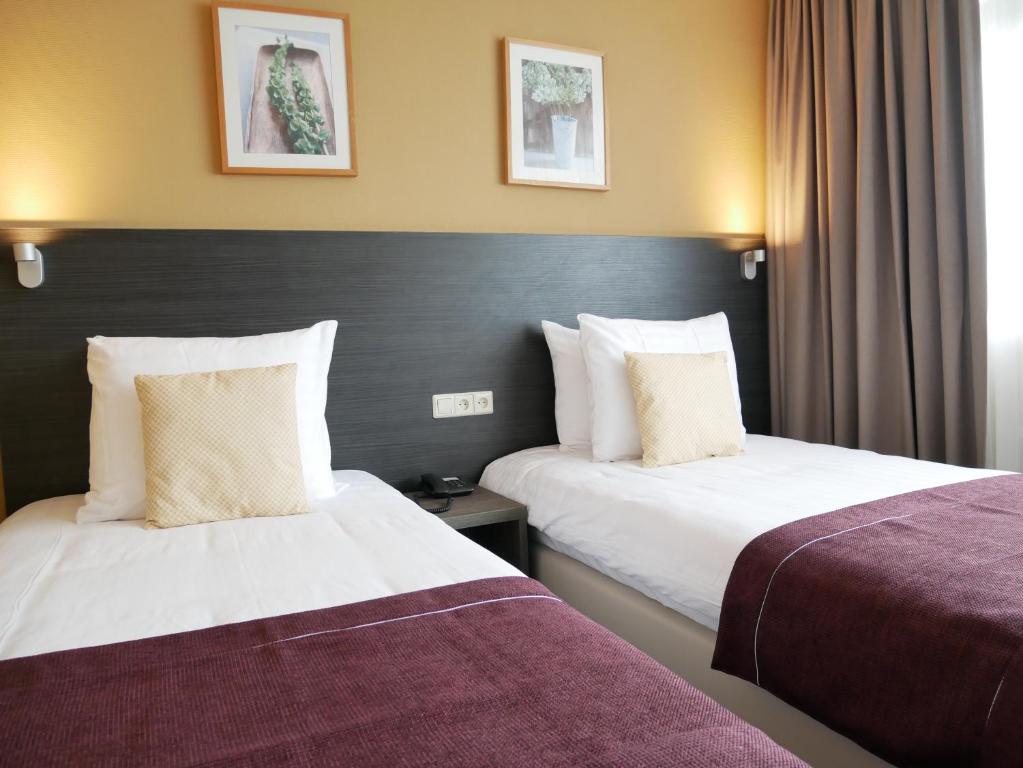 Postel nebo postele na pokoji v ubytování Hotel het Oosten