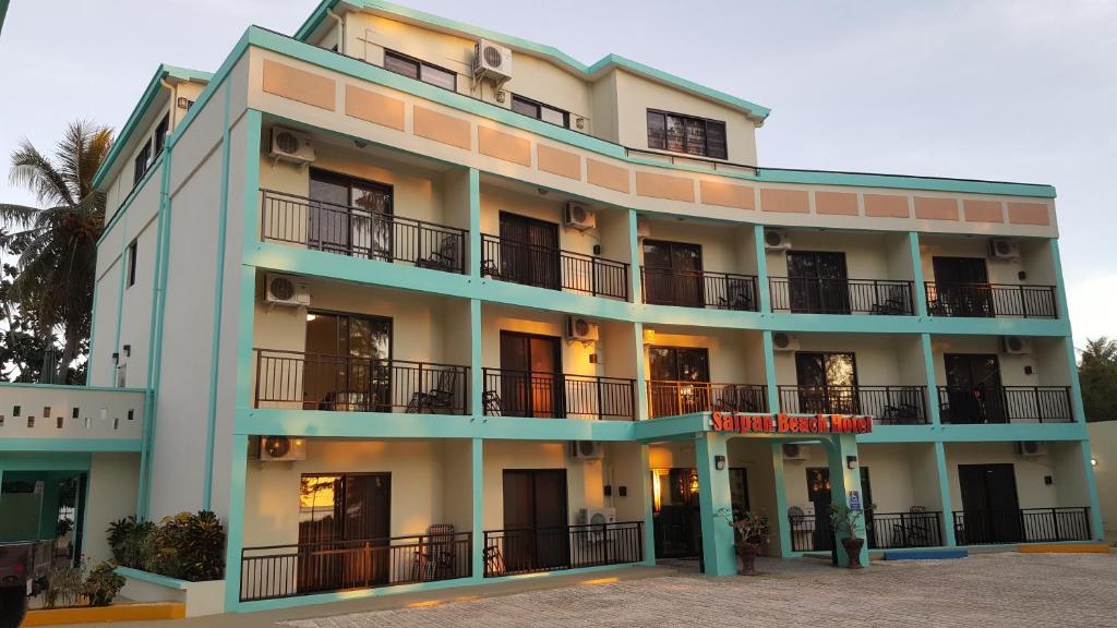 a building with balconies on the side of it at Saipan Beach Hotel in Saipan