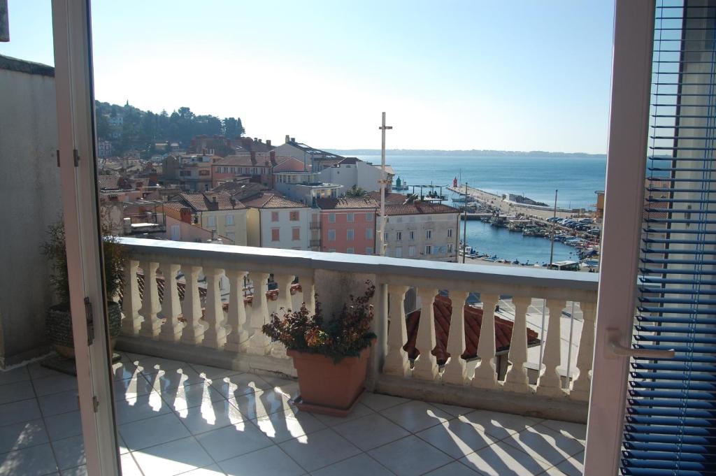a balcony with a view of a city and the ocean at Amazing View Pirano in Piran