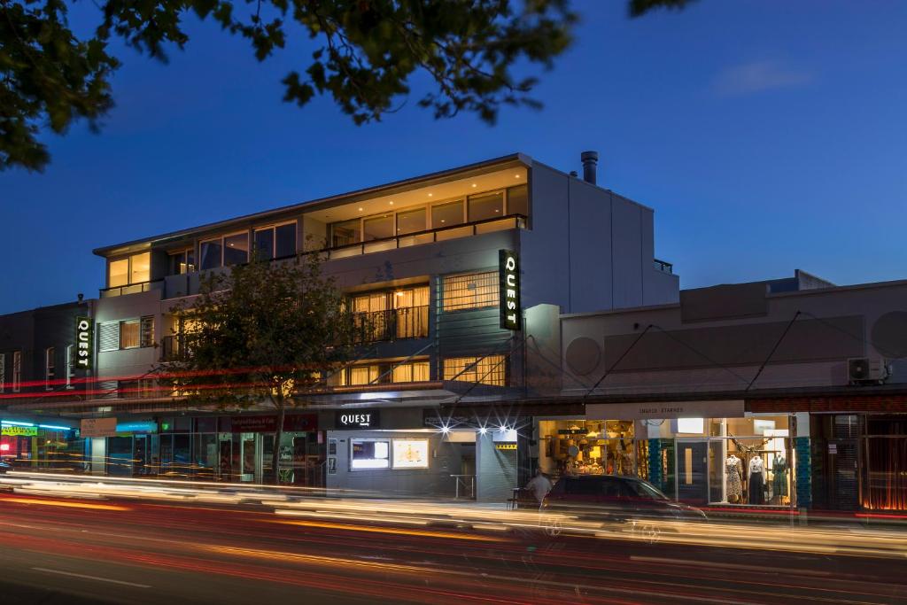 a building on the corner of a street at night at Quest Ponsonby Serviced Apartments in Auckland