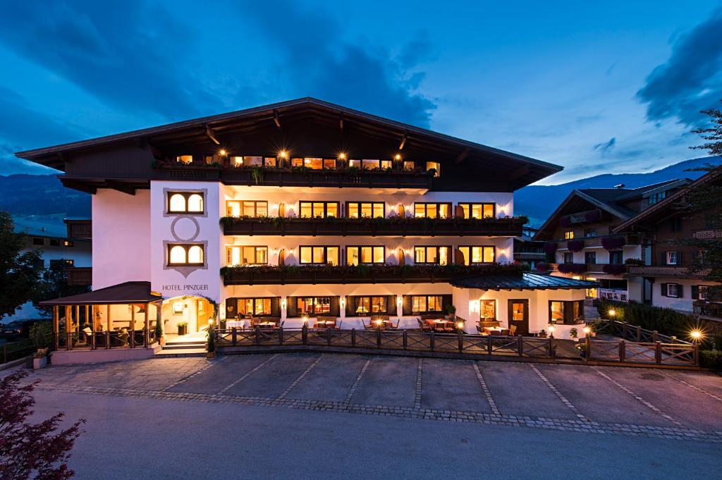 a large building with a lot of windows at night at Hotel Zum Pinzger in Stumm