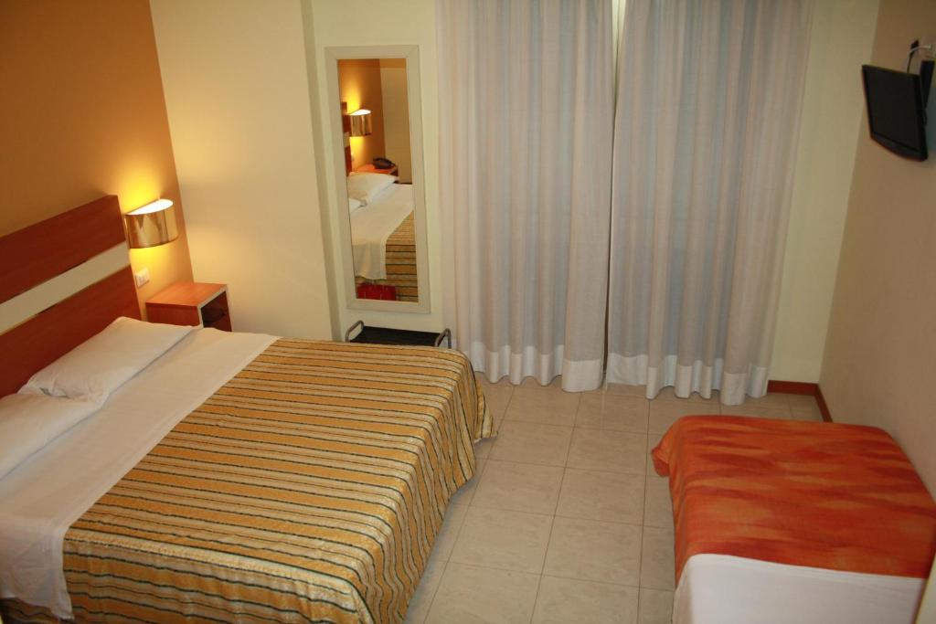 Postel nebo postele na pokoji v ubytování Hotel GF