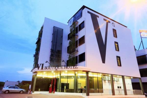 a building with a v sign on the side of it at Vi Boutique Hotel in Kuala Selangor