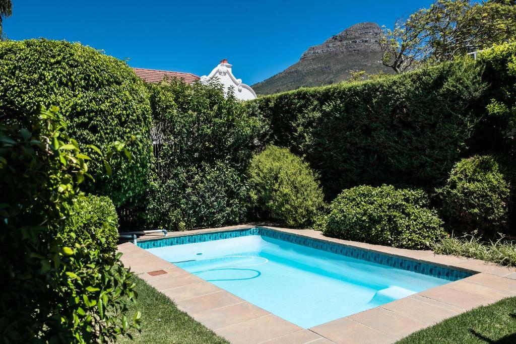
a house with a pool and a tennis court at 5 Camp Street Guesthouse & Self-catering in Cape Town
