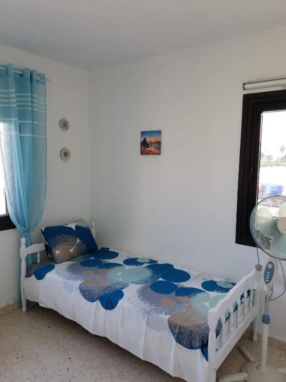 a bedroom with a bed with a blue curtain at Kings Avenue - Natalia's Apt in Paphos
