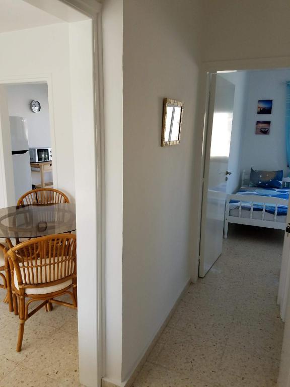 a room with a table and a room with a bed at Kings Avenue - Natalia's Apt in Paphos