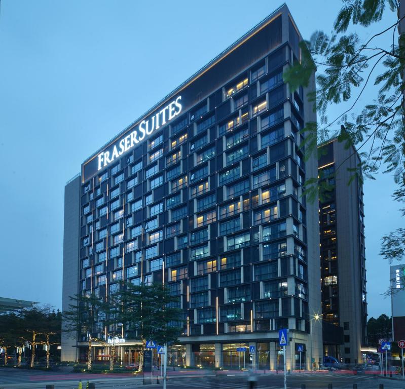 a tall building with a sign on it at Fraser Suites Shenzhen, Near Huaqiang North Business Zone and next to shopping mall complex, with direct subway access in Shenzhen