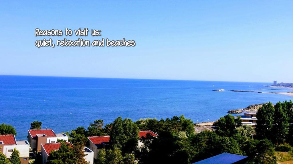 a view of a large body of water with houses at Apartments For You in Olimp