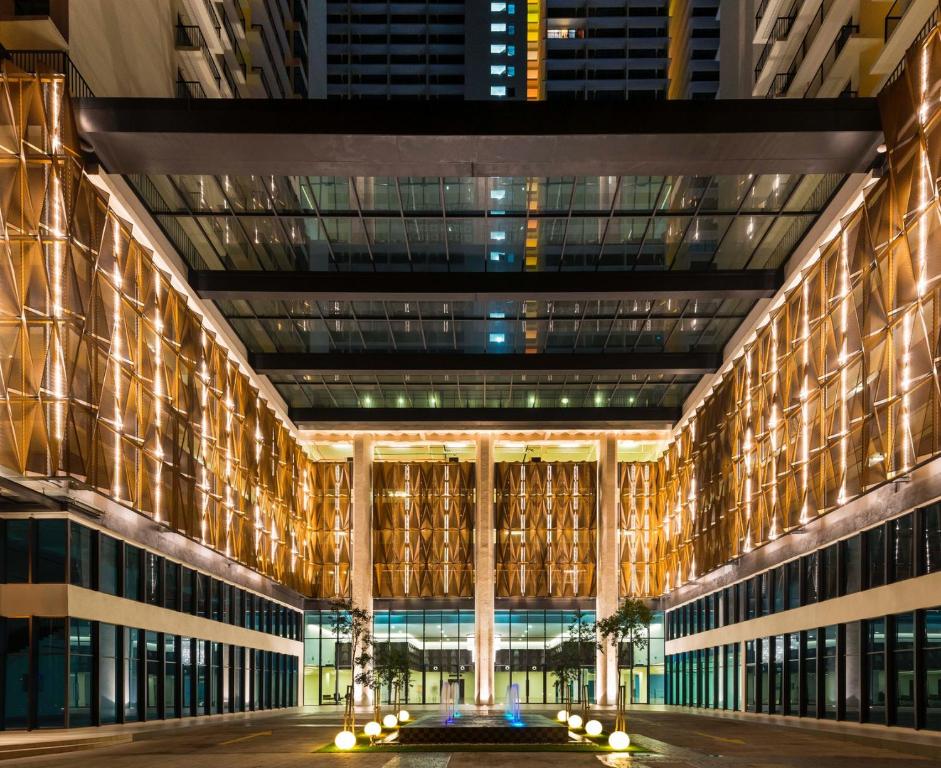 a view of the building at night at De Houz @ Setia Alam Trefoil Homestay in Shah Alam