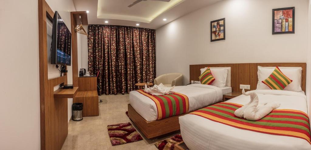 Postel nebo postele na pokoji v ubytování Hotel Suktara International