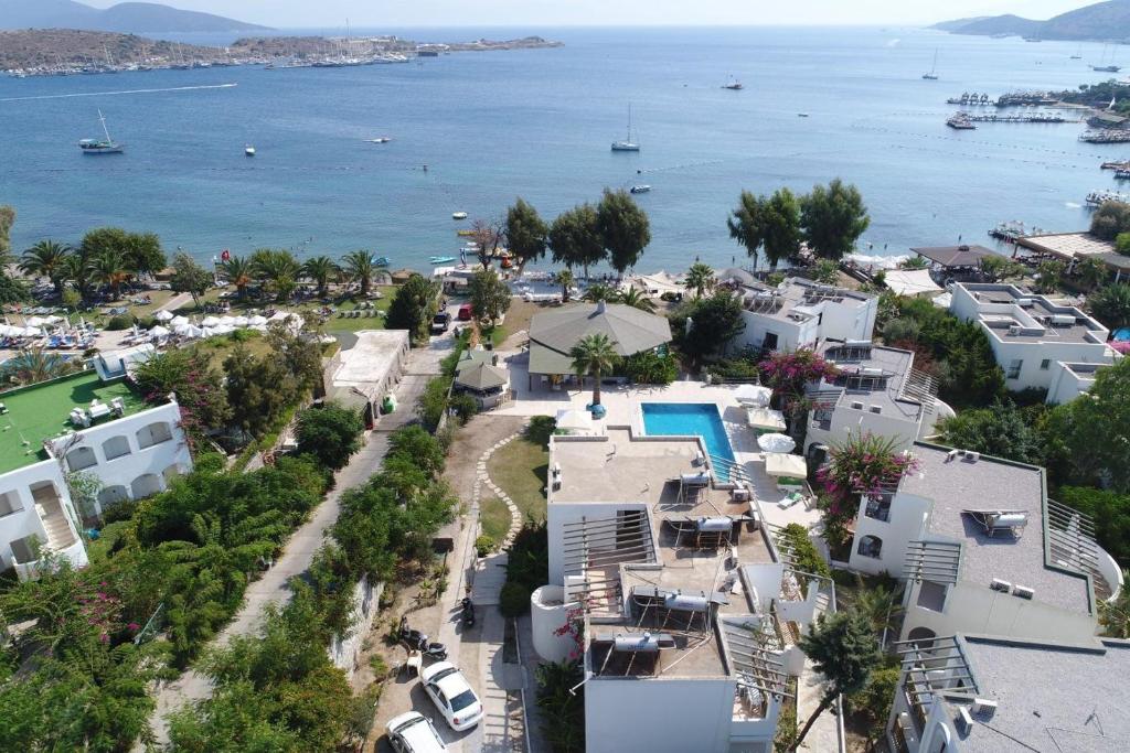 an aerial view of a resort with the ocean at Gumbet Cove Hotel in Gümbet